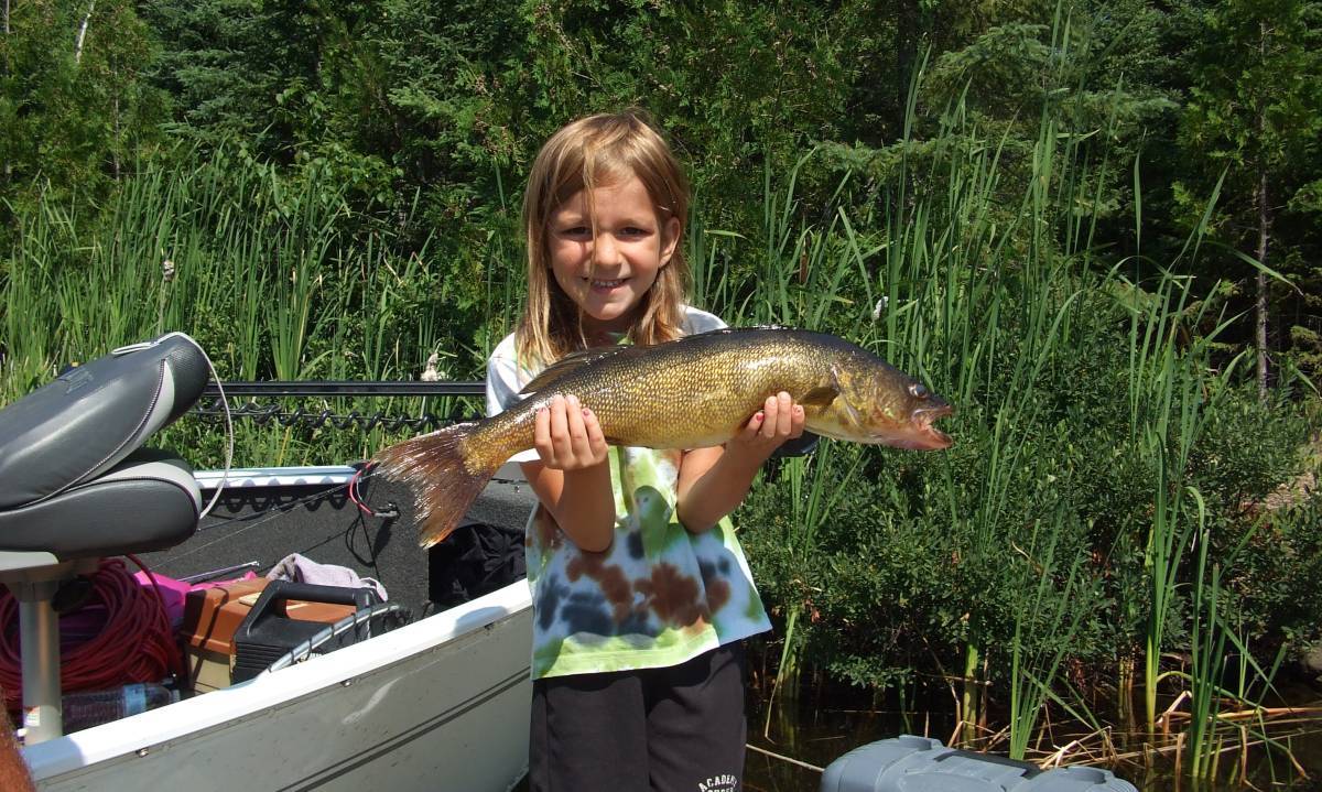 Young girl holding a fish